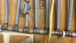 Close-up of gray polybutylene pipe with PB2110 stamping
